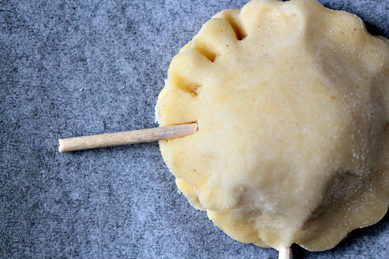 Pie pops recipe with step by step pictures. Seal and decorate the edges with a short piece of a lollipop stick or a wooden skewer.